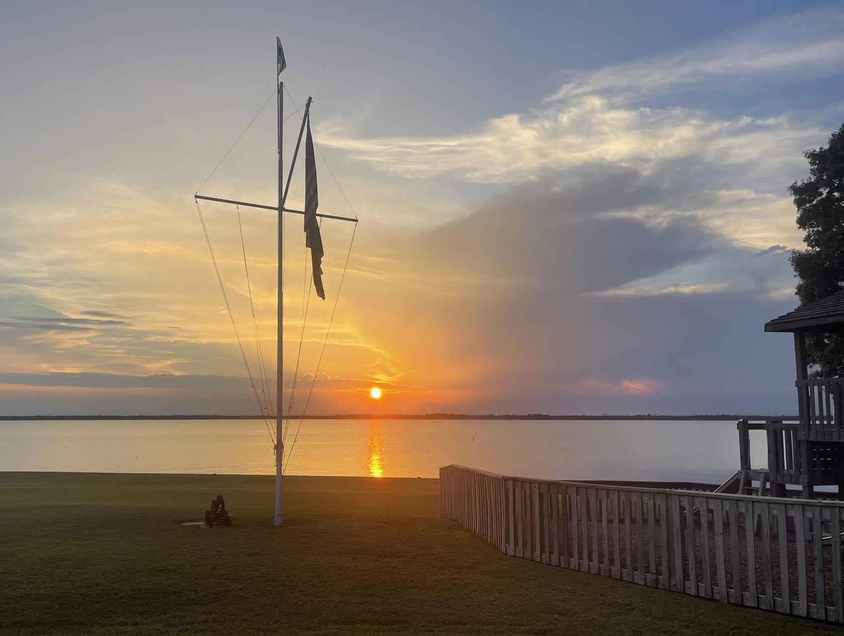 Club flagpole and lawn at sunset overlooking Lake Ray Hubbard